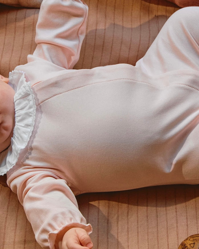 Pink babygrow with ruffled lace collar + bonnet