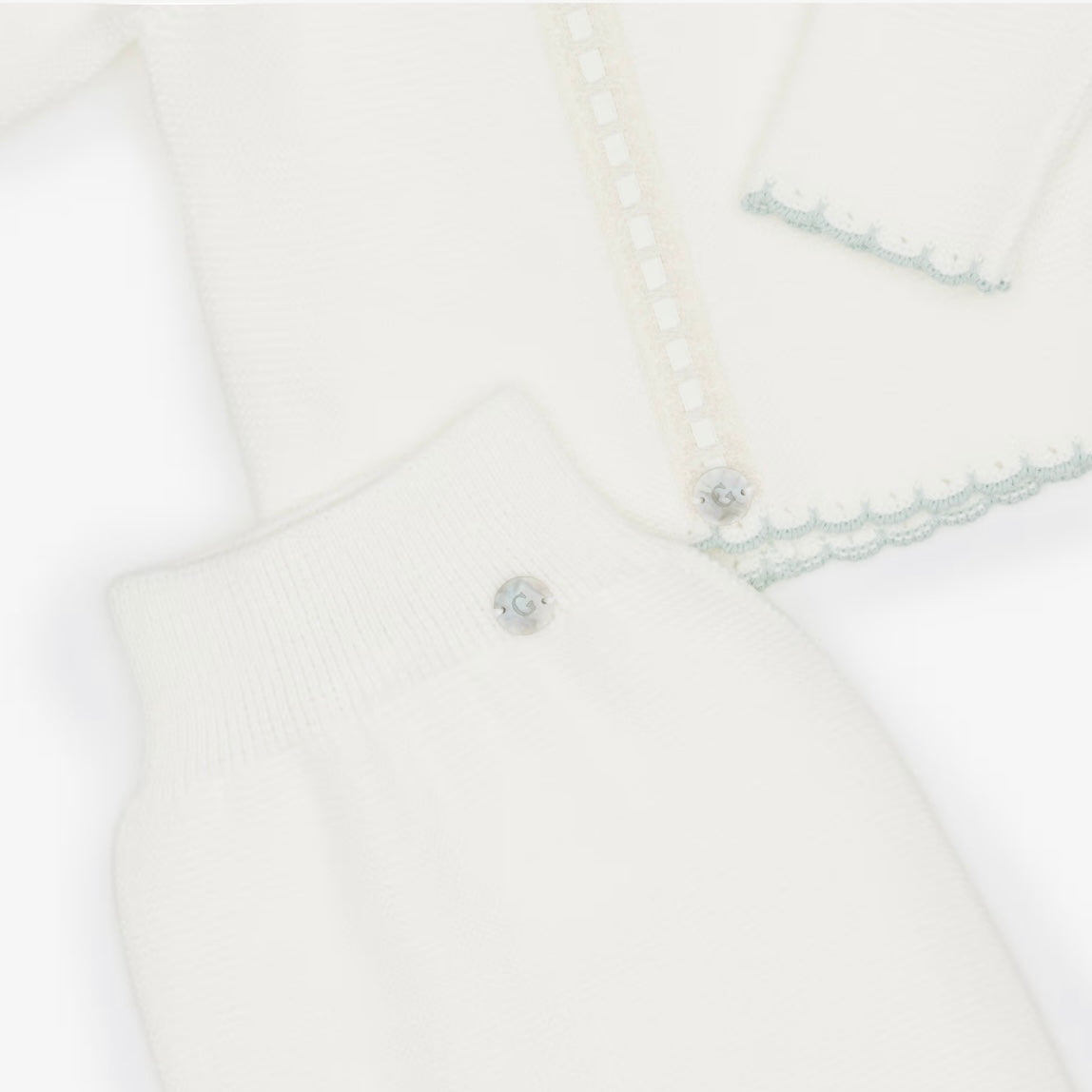 Ivory babygrow set with pale green trims